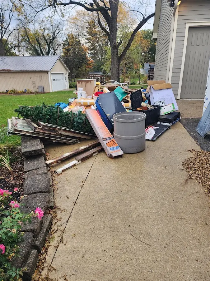 Dumpster being loaded with debris for Roofing Dumpster Rental in Whiteville